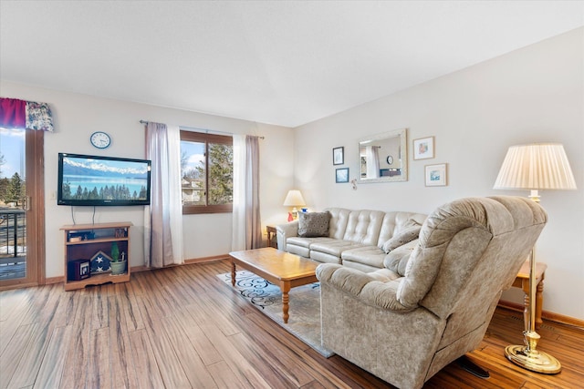 living area featuring baseboards and wood finished floors