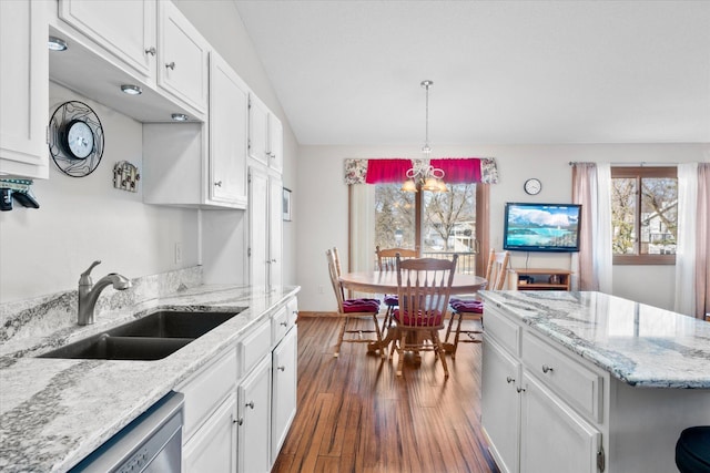 kitchen featuring a sink, dark wood-type flooring, stainless steel dishwasher, and white cabinetry