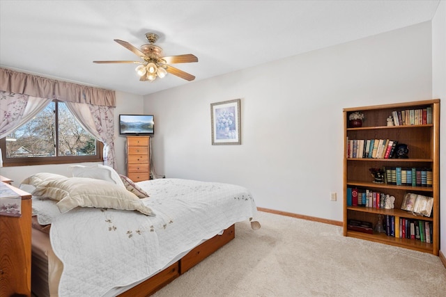 carpeted bedroom featuring baseboards and ceiling fan