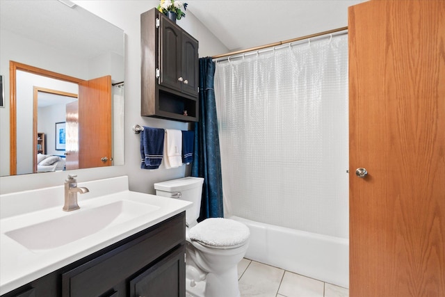 bathroom featuring tile patterned floors, shower / bath combo with shower curtain, toilet, ensuite bath, and vanity