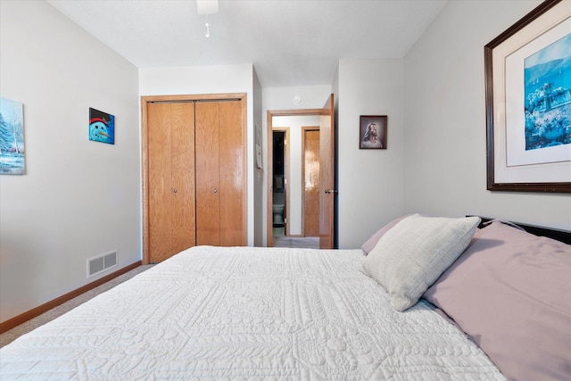 bedroom featuring a closet, visible vents, a ceiling fan, and baseboards