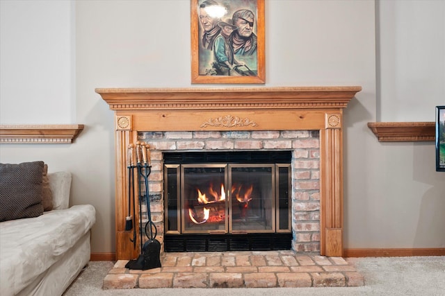 interior details featuring a brick fireplace, baseboards, and carpet floors