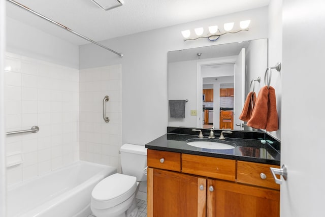 bathroom with bathing tub / shower combination, toilet, and vanity