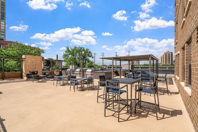 view of patio with an outdoor fireplace