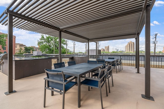 view of patio / terrace featuring a city view, outdoor dining space, and a pergola