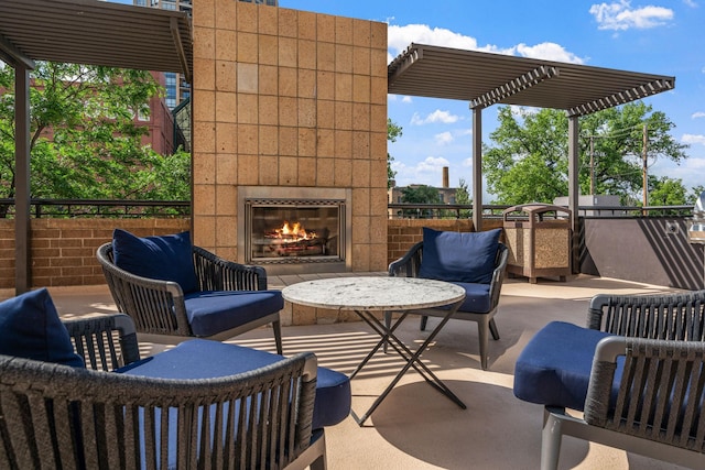 view of patio / terrace featuring a glass covered fireplace