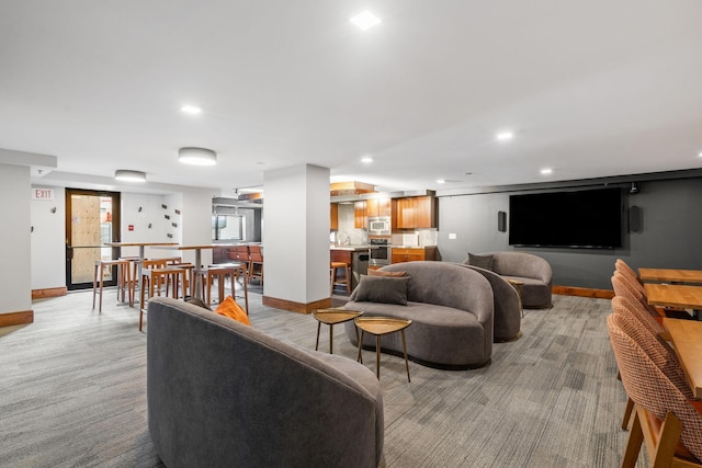 living area featuring baseboards, recessed lighting, light colored carpet, and a community bar
