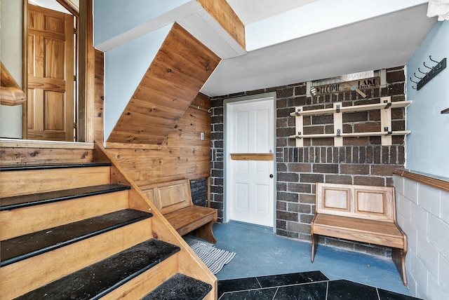 stairs with concrete block wall and concrete floors