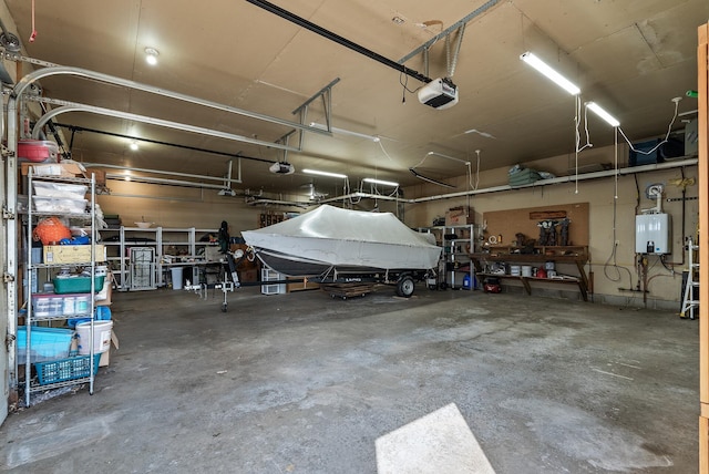 garage featuring water heater, a workshop area, and a garage door opener