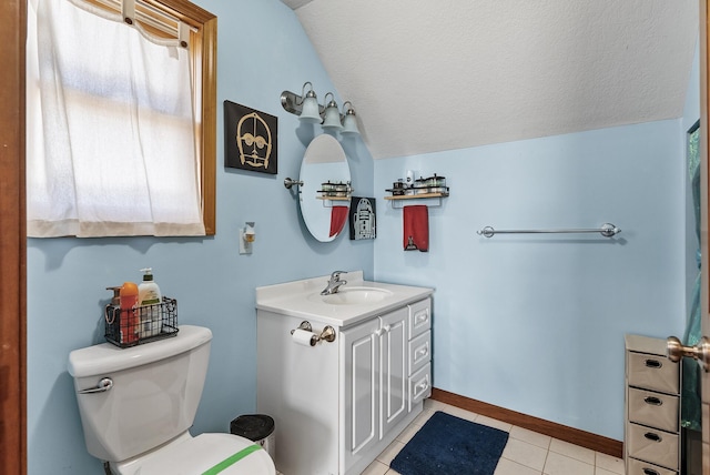 bathroom featuring vanity, toilet, tile patterned flooring, and a textured ceiling