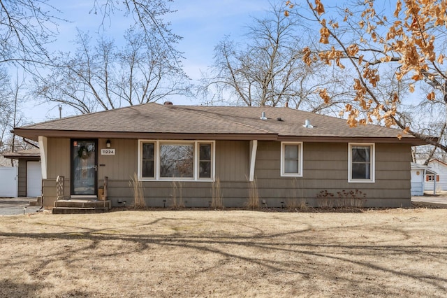 view of front of house with roof with shingles