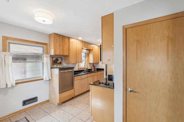 kitchen with a sink, stainless steel dishwasher, dark countertops, light tile patterned floors, and black electric stovetop