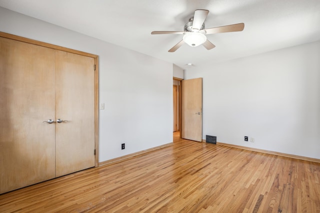 unfurnished bedroom with visible vents, ceiling fan, light wood-type flooring, and baseboards