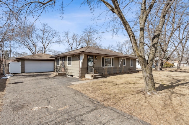 single story home with a garage, driveway, and a shingled roof