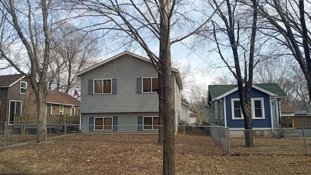 back of house featuring a fenced backyard and a residential view