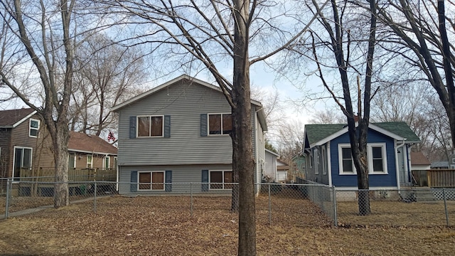 back of property featuring a residential view and a fenced backyard