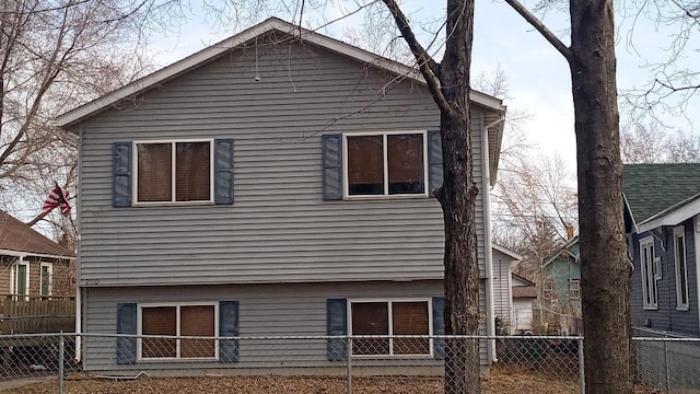 rear view of property with fence