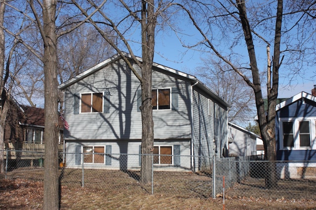 back of house with a fenced front yard