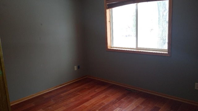 220 35th Ave N, Saint Cloud, MN 56303 - spare room featuring dark wood finished floors and baseboards
