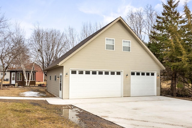 view of home's exterior with a garage and driveway