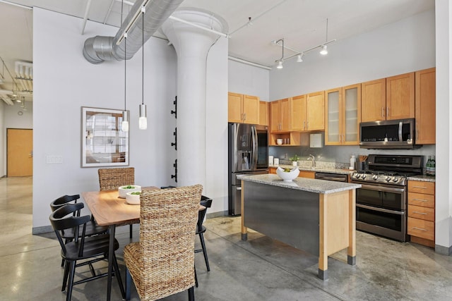 250 Park Ave Unit 606, Minneapolis, MN 55415 - kitchen with stainless steel appliances, a towering ceiling, finished concrete flooring, a center island, and glass insert cabinets