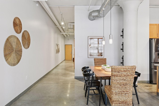 250 Park Ave Unit 606, Minneapolis, MN 55415 - dining space featuring concrete floors and a high ceiling
