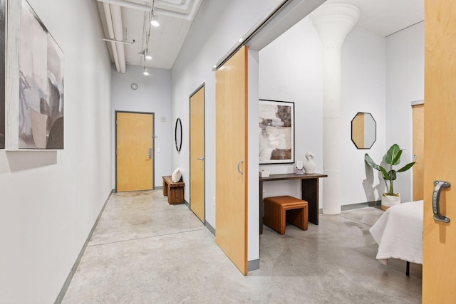 250 Park Ave Unit 606, Minneapolis, MN 55415 - hall with concrete flooring, a high ceiling, and rail lighting