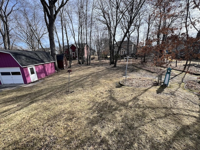 view of yard featuring an outbuilding, a barn, and a garage