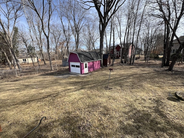 view of yard with a garage, an outbuilding, and a barn