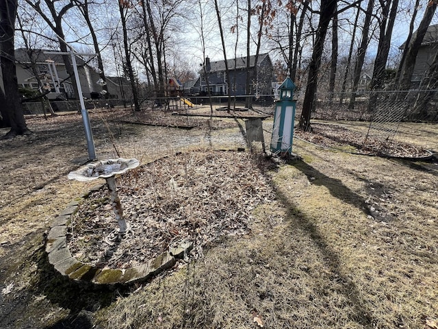 view of yard featuring a playground and fence