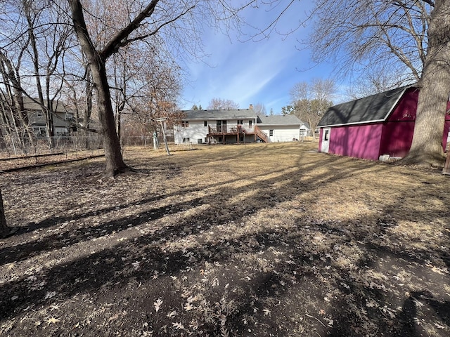 view of yard featuring an outbuilding, a barn, and a deck