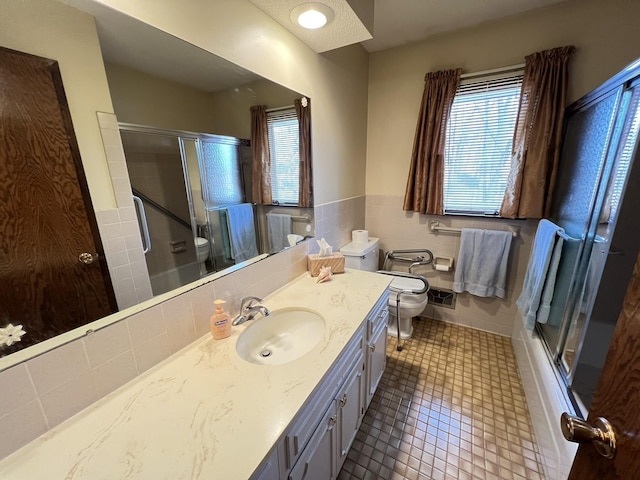 bathroom featuring a shower stall, toilet, and a healthy amount of sunlight