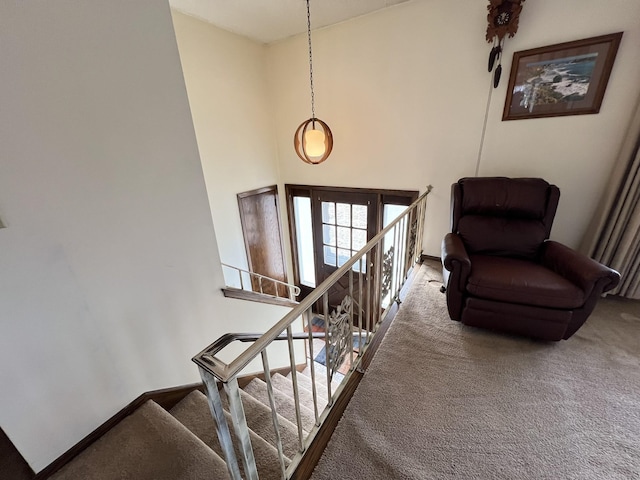 stairway with baseboards and carpet floors