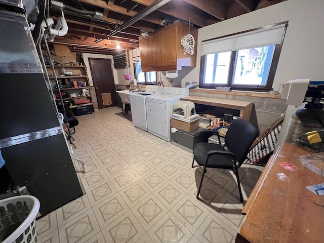 kitchen featuring brown cabinetry, light countertops, and washer and clothes dryer