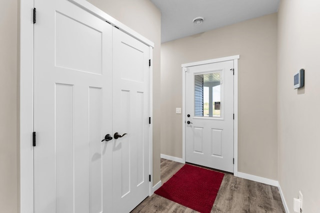 entryway featuring baseboards and wood finished floors