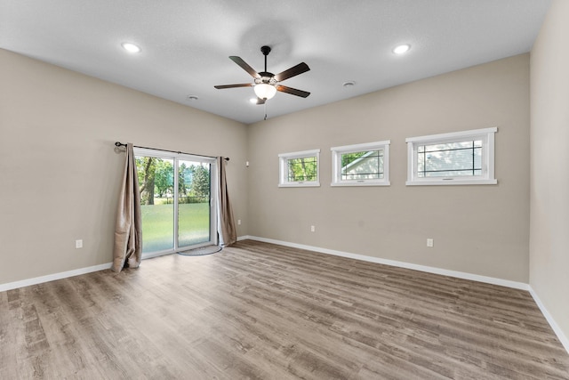 unfurnished room featuring recessed lighting, baseboards, light wood-style floors, and a ceiling fan