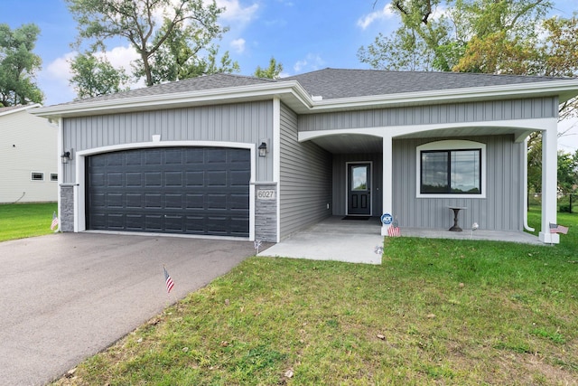 ranch-style home with driveway, a front lawn, a garage, and roof with shingles