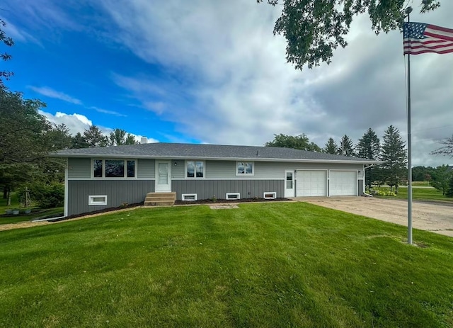 ranch-style home with a garage, concrete driveway, and a front lawn