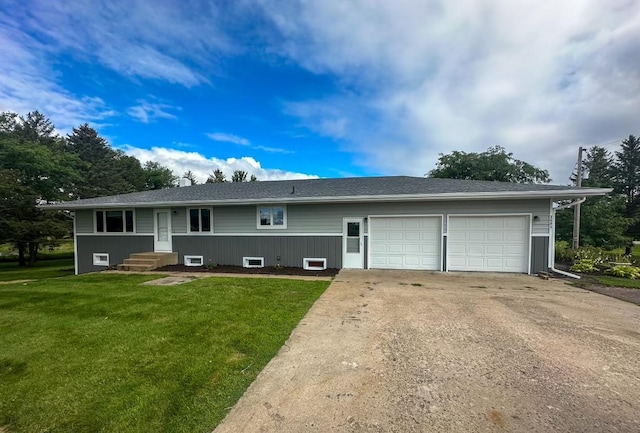 ranch-style home featuring a front yard, an attached garage, and driveway