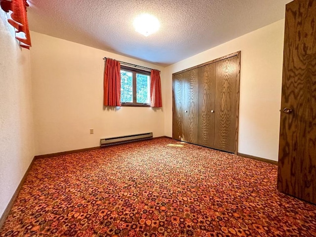 unfurnished bedroom featuring baseboards, a closet, a textured ceiling, a baseboard heating unit, and carpet flooring