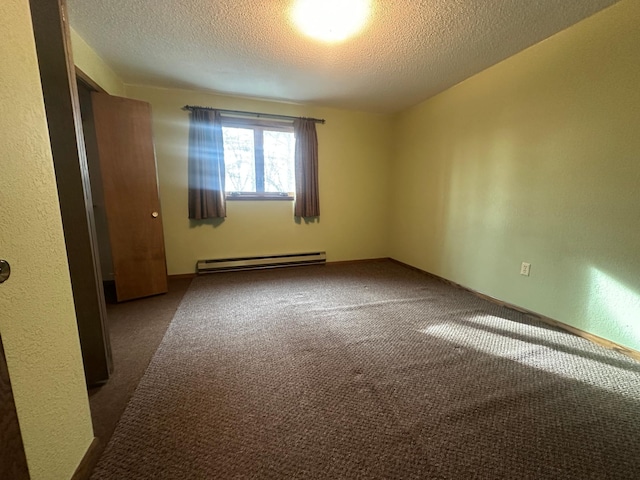 unfurnished room featuring a baseboard heating unit, carpet flooring, a textured wall, and a textured ceiling