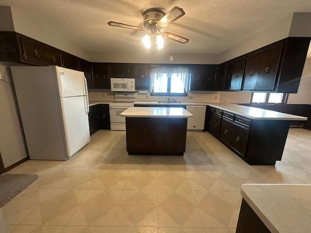 2593 6th St S, Sartell, MN 56377 - kitchen with white appliances, a sink, a ceiling fan, light countertops, and a textured ceiling