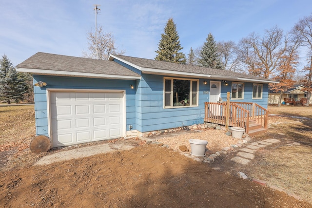 single story home with dirt driveway, an attached garage, and roof with shingles