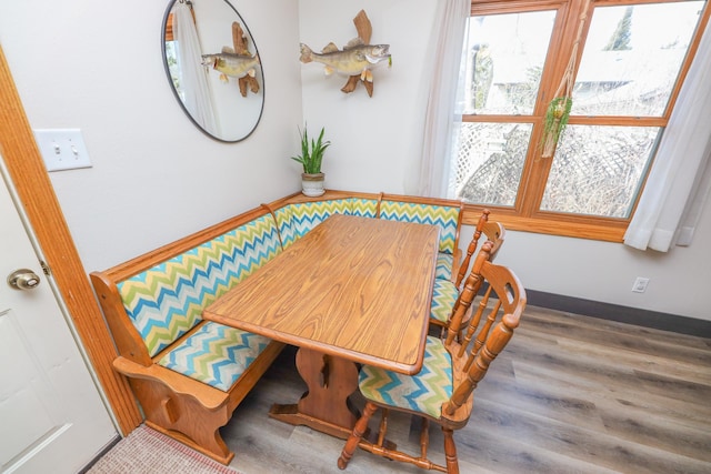 dining room with baseboards and wood finished floors