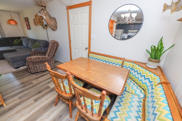 dining area with a notable chandelier and wood finished floors