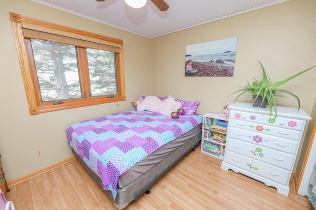 bedroom with baseboards, wood finished floors, a ceiling fan, and ornamental molding