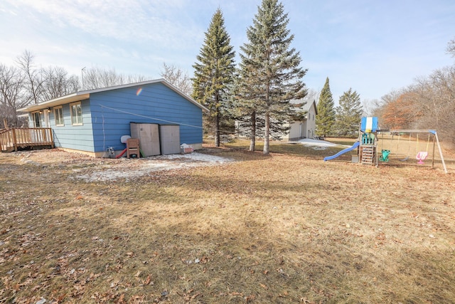 view of yard with a playground and a deck