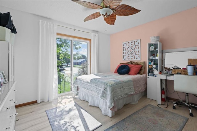 bedroom with baseboards, light wood-style floors, and a ceiling fan