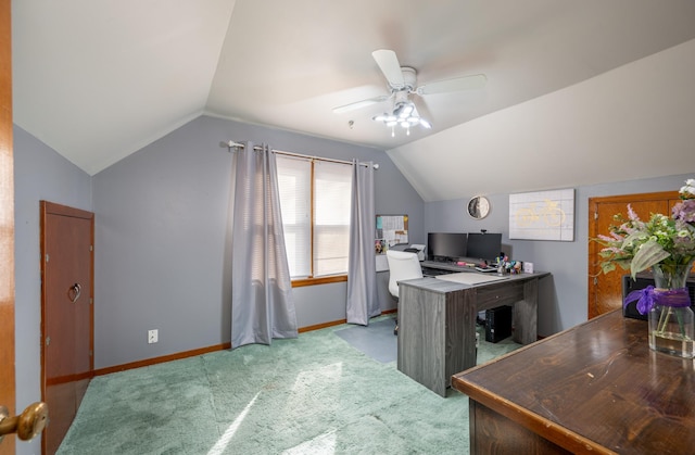 carpeted office space with ceiling fan, baseboards, and lofted ceiling