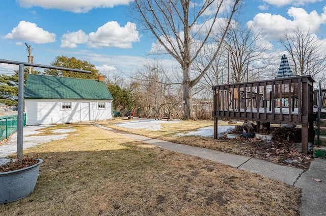 view of yard with a wooden deck, an outdoor structure, and fence